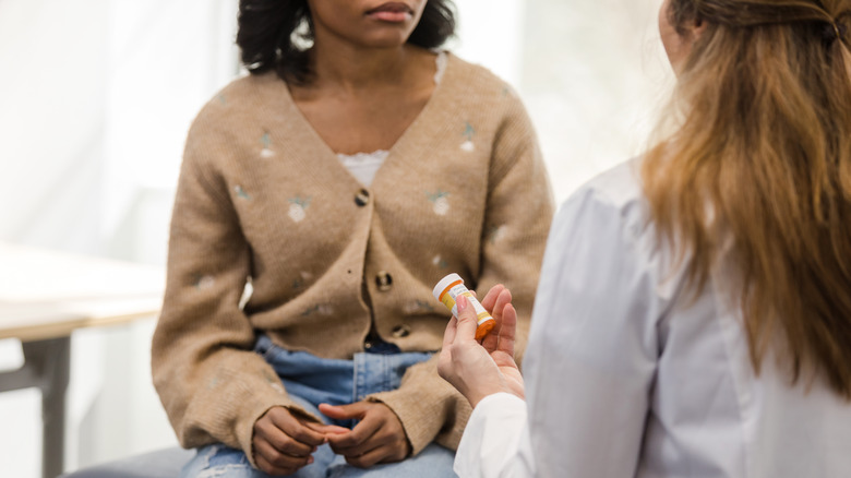 doctor giving medication to patient