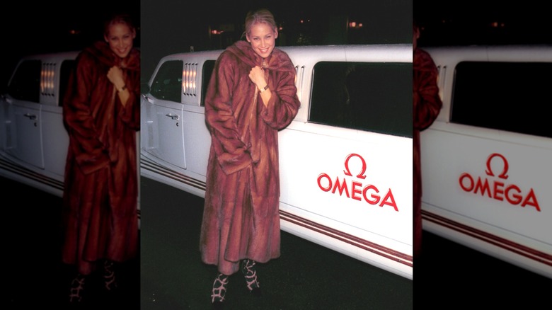 Anna Kournikova in long fur coat beside Omega limo