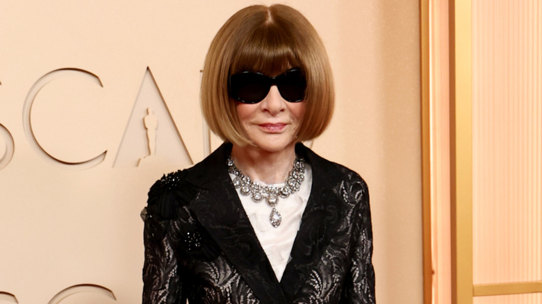 Anna Wintour on the red carpet in a black lace jacket