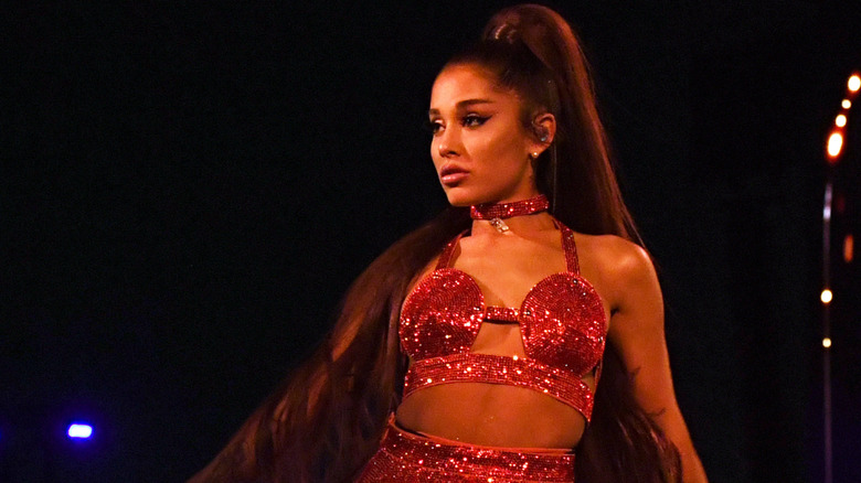 Ariana Grande on stage in a red sparkly top