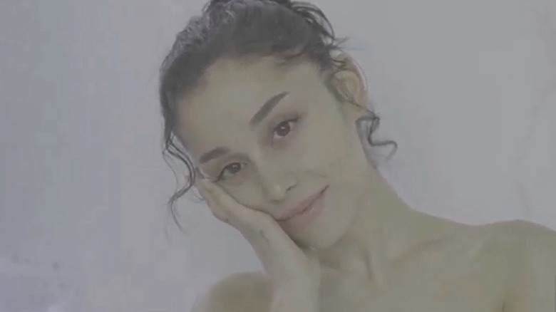 Ariana Grande with curly hair posing without makeup