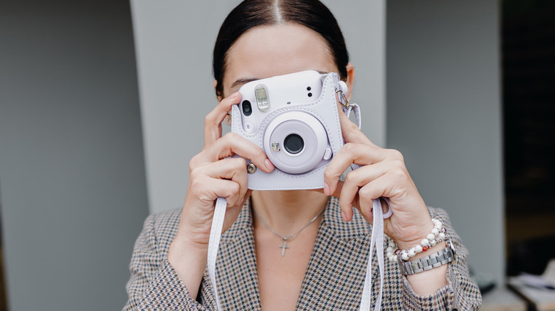 Woman with a Polariod camera
