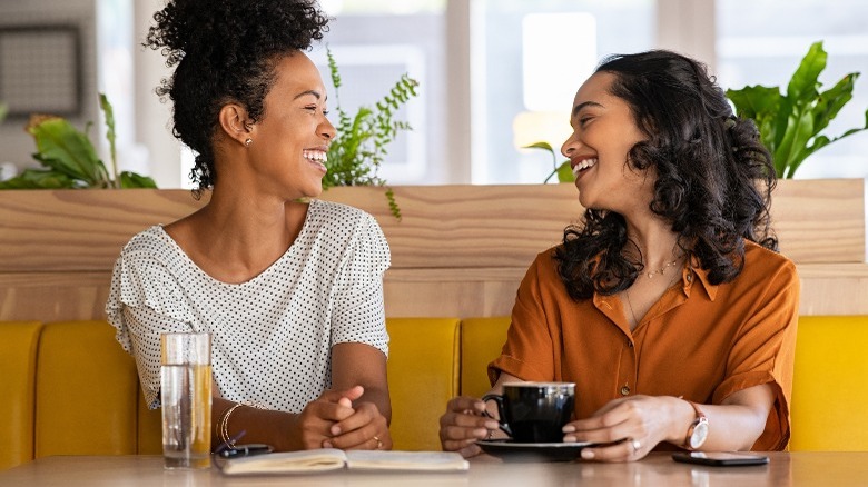 Two women talking at a cafe