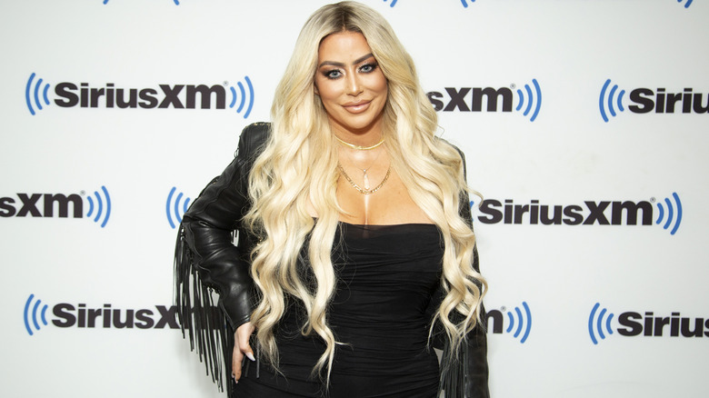 Aubrey O'Day smiles on the red carpet in 2022