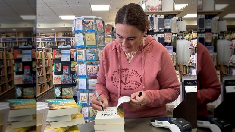 Emma Grey signs copies of her books for fans