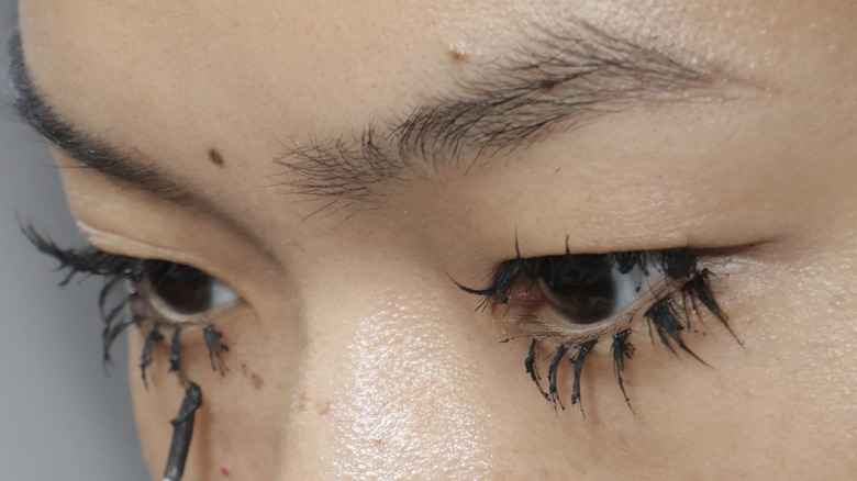 Woman with black clumpy mascara