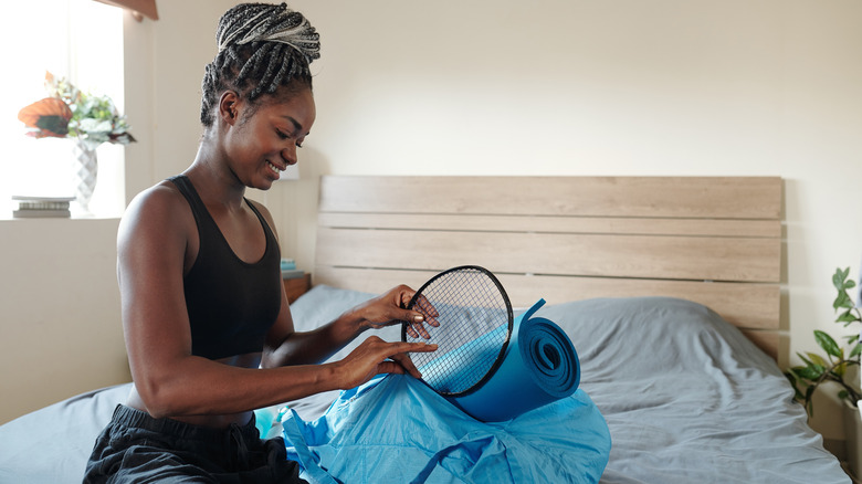 woman packing badminton racket