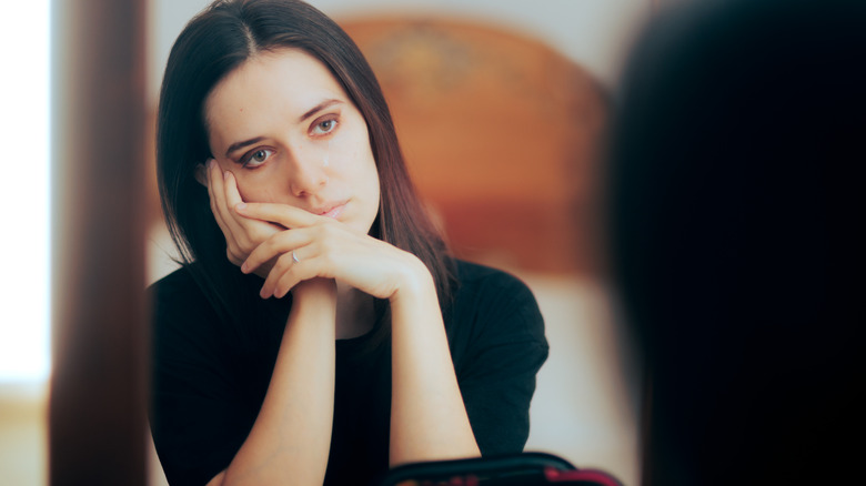 woman looking in mirror