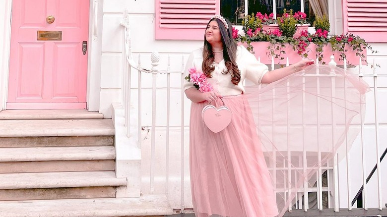 woman posing in front of home