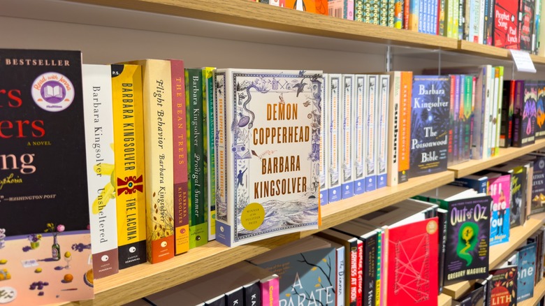 Several of Barbra Kingsolver's books on a shelf in a bookstore