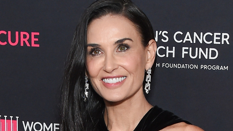 Demi Moore smiling at a fashion show in 2024