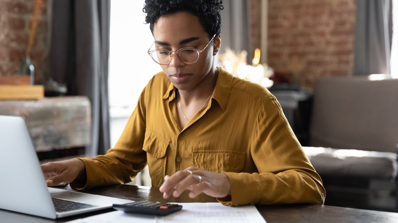 Person building budget on computer