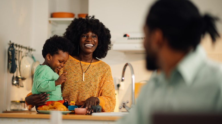 A woman tending to her kid and partner