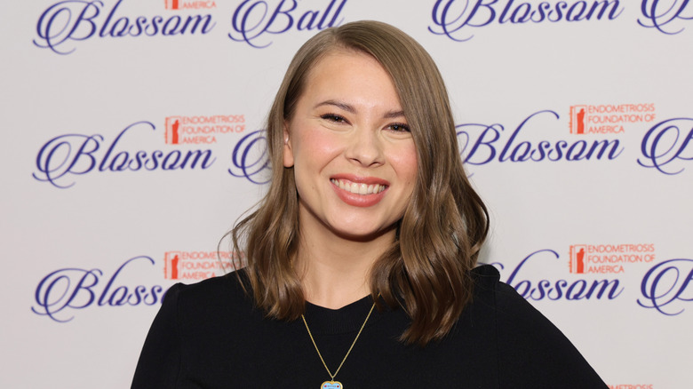 Bindi Irwin wearing a black dress
