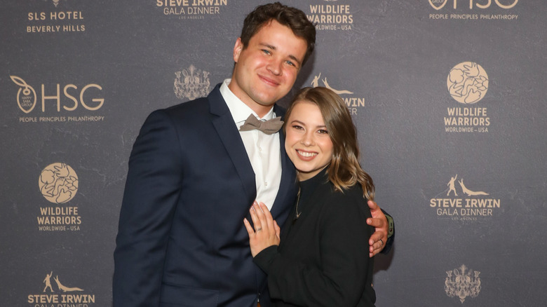 Bindi Irwin and Chandler Powell hugging on the red carpet