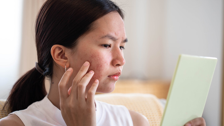 Woman touching her face