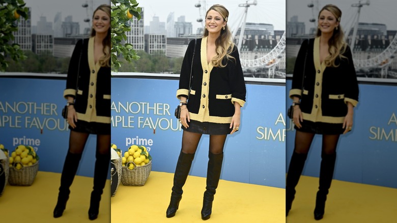 Blake Lively wearing black and yellow on a red carpet