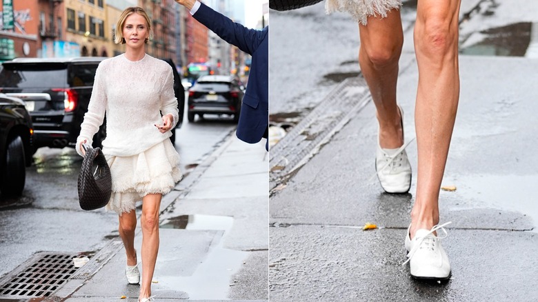 Charlize Theron walks wearing a knitted jumper, a skirt and white pumps.