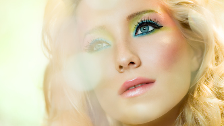 Woman wearing colorful, ethereal makeup