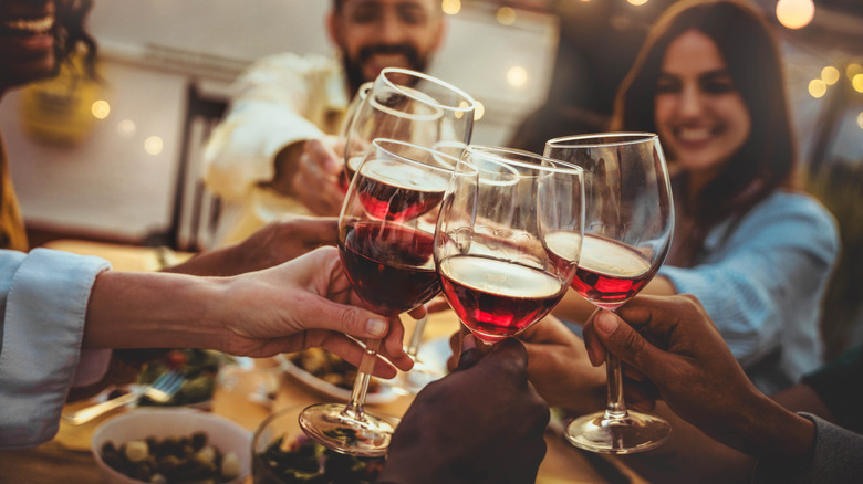 People toasting with wine glasses