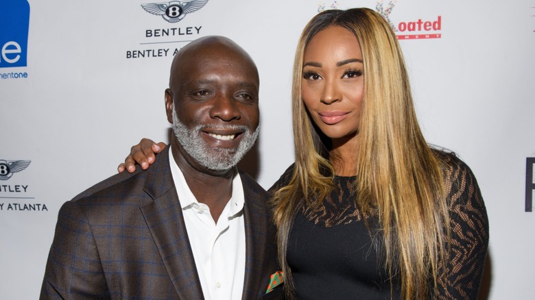 Cynthia Bailey and Peter Thomas smiling together on the red carpet