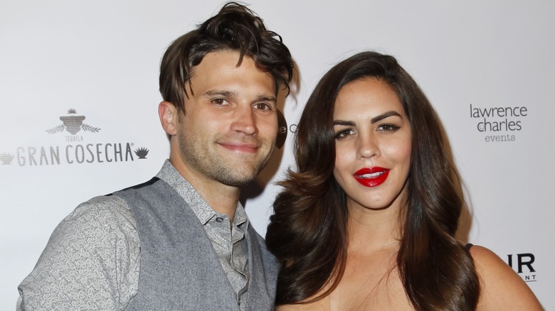 Tom Schwartz and Katie Maloney smiling and posing together on the red carpet