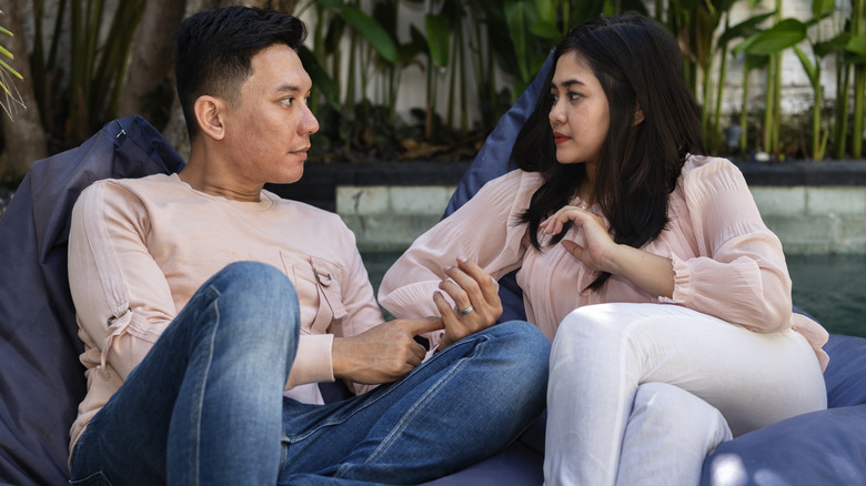 couple on couch debating