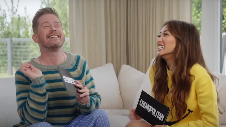 Macaulay Culkin and Brenda Song laughing during Cosmo game
