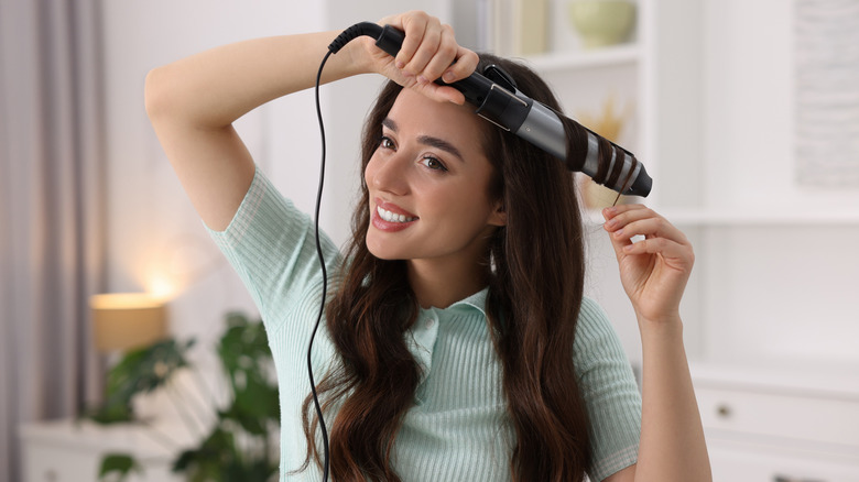 Woman curling hair