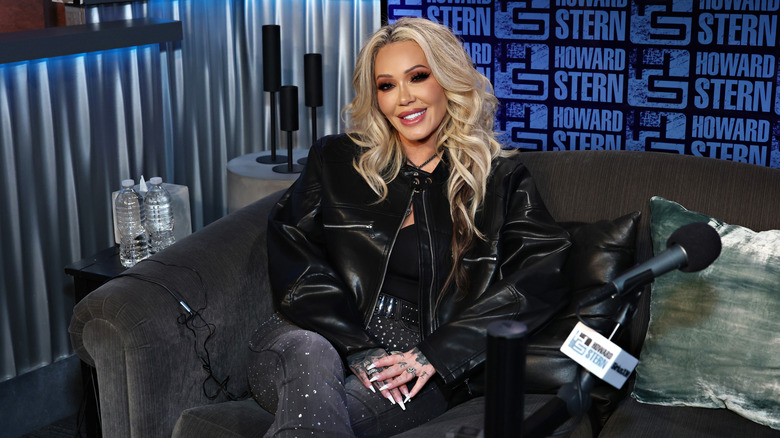 Bunnie Xo sitting in a recording studio and wearing a leather jacket
