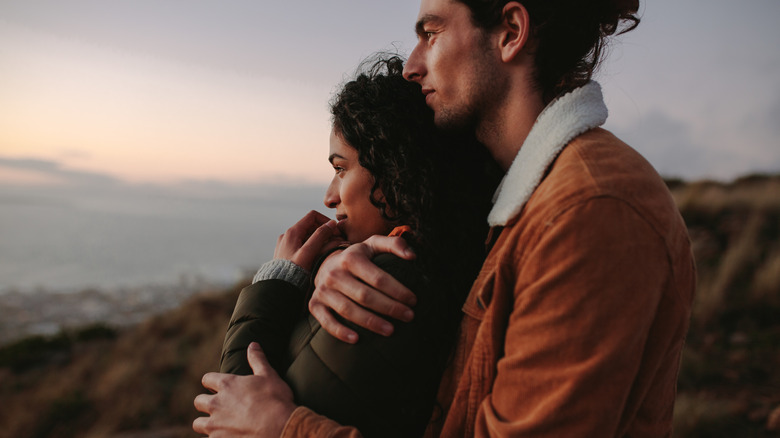 A couple outside, hugging