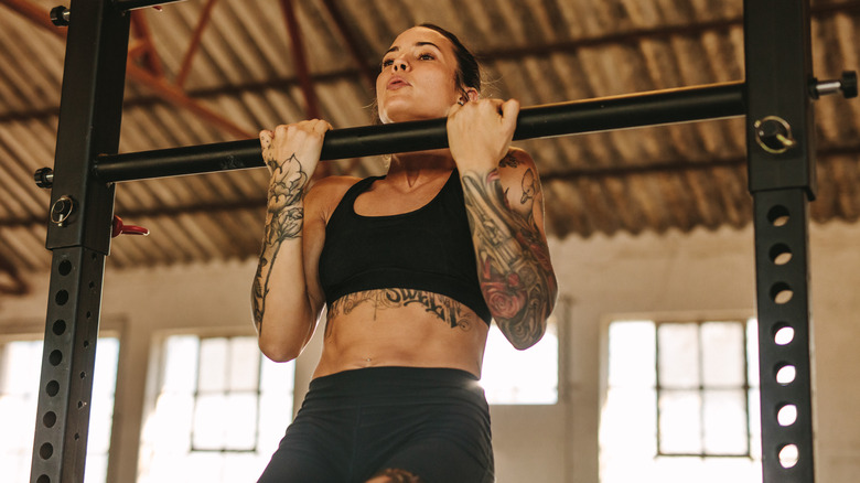 Tattooed woman exercising