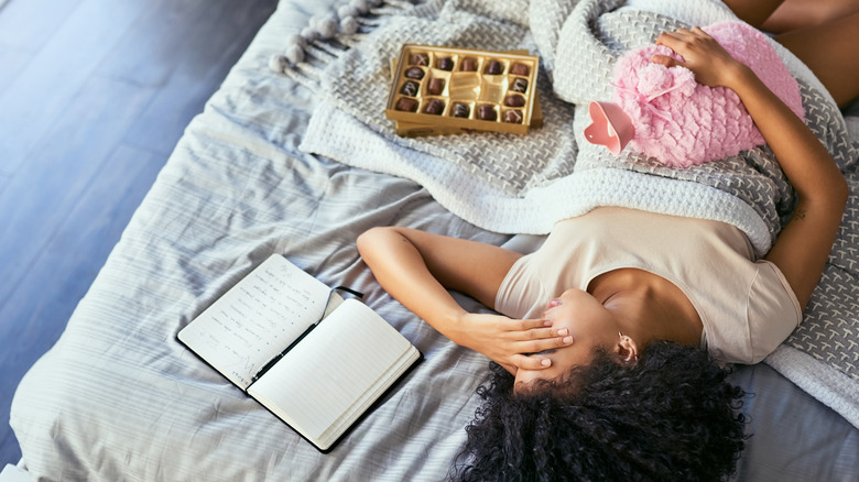 Woman in bed with cramps