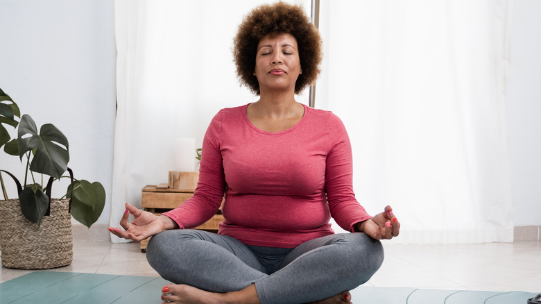 Woman calmly meditating 