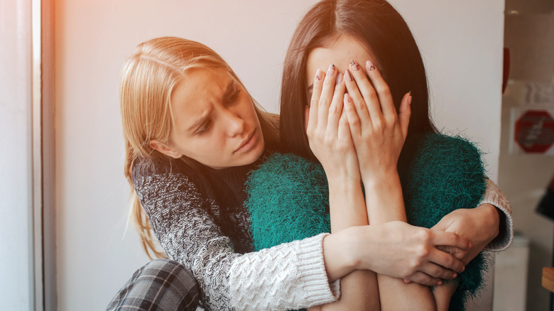 woman consoling friend