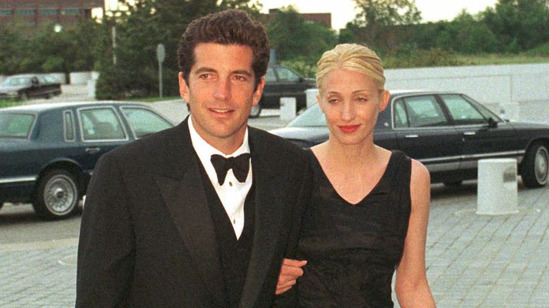 John F. Kennedy Jr. and Carolyn Bessette in a black dress at an event