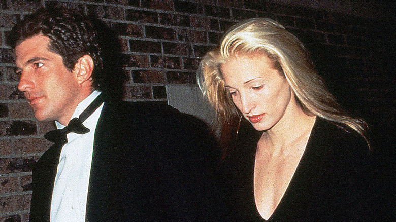 John F. Kennedy Jr. in a tuxedo and Carolyn Bessette in a black dress