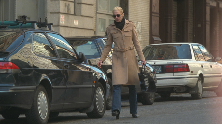 Carolyn Bessette Kennedy in a camel color coat and jeans in New York