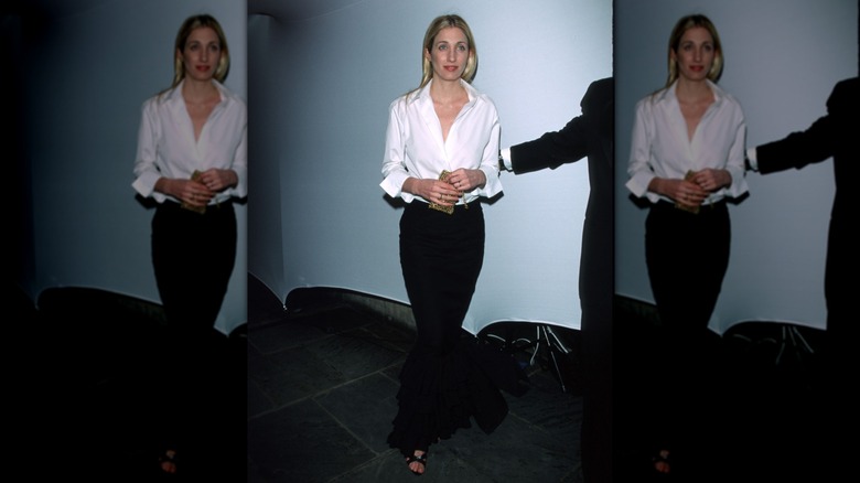 Carolyn Bessette Kennedy wearing a white shirt with a black maxi skirt
