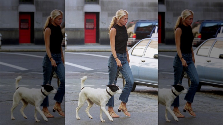 Carolyn Bessette Kennedy walking her dog in cropped jeans and strappy sandals