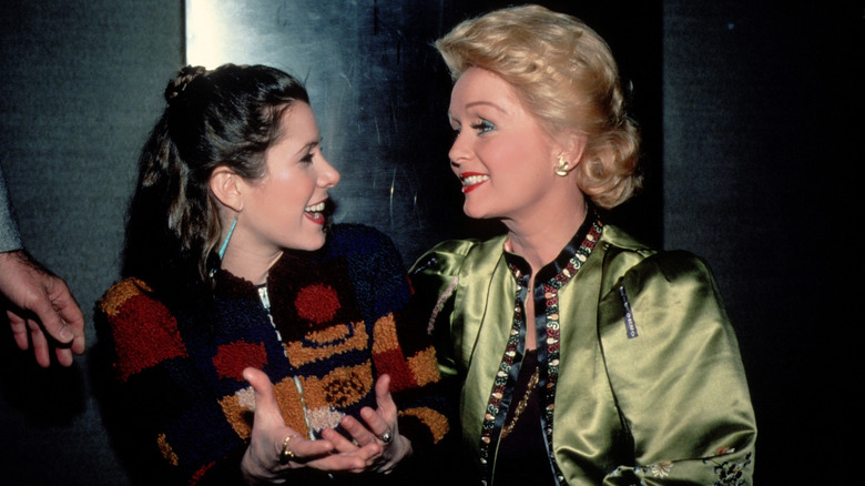 Carrie Fisher and mother Debbie Reynolds pictured laughing with one another in 1983