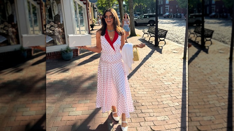 Kaitlan Collins in Cape Cod in July 2025, holding a box on the sidewalk