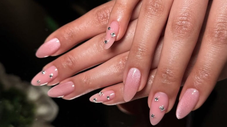 Pink cat eye almond nails with crystal accents