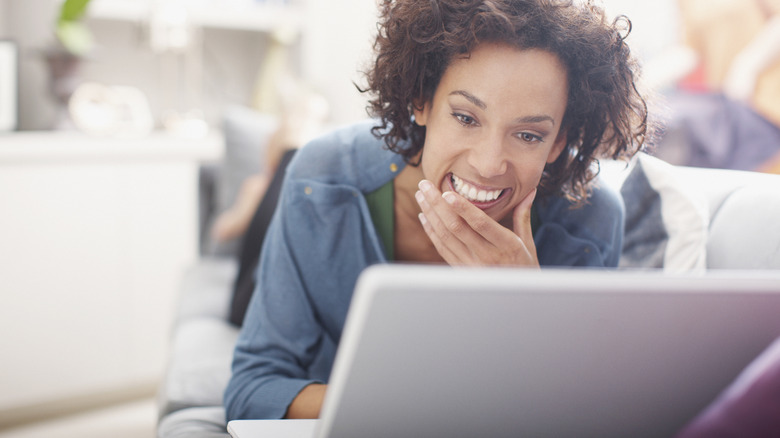Woman smiling at a computer