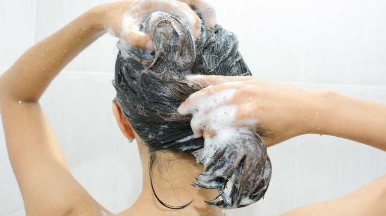 Woman shampooing hair