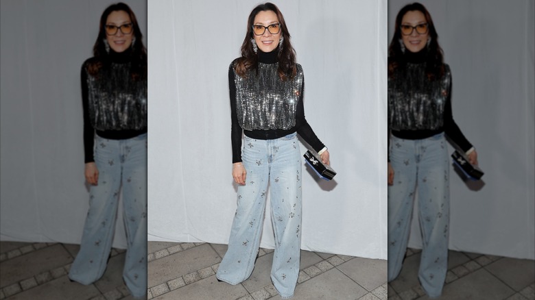 Michelle Yeoh in a sparkly black top and sparkly denim