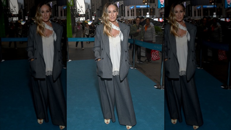 Sarah Jessica Parker attends Primark flagship launch event on May 6, 2026 in New York City wearing a gray suit with a white scarf