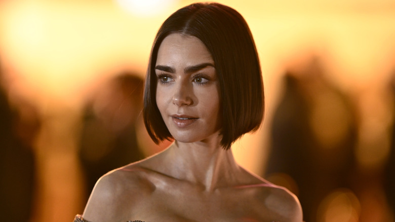 Lily Collins posing while slightly arching her eyebrow