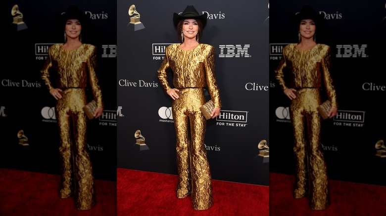 Shania Twain in a gold co-ord and black cowboy hat at a pre-Grammy gala in 2024