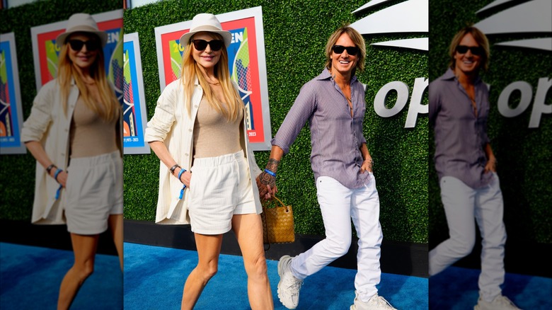 Nicole Kidman in white suit and bermuda hat next to Keith Urban